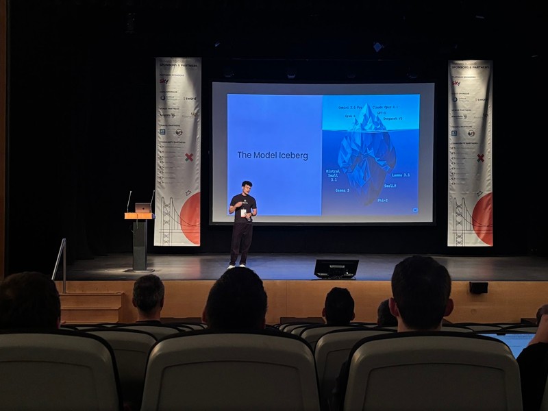 Iury Souza presenting at Droidcon Lisbon 2025 - The Model Iceberg slide showing the complexity of AI models